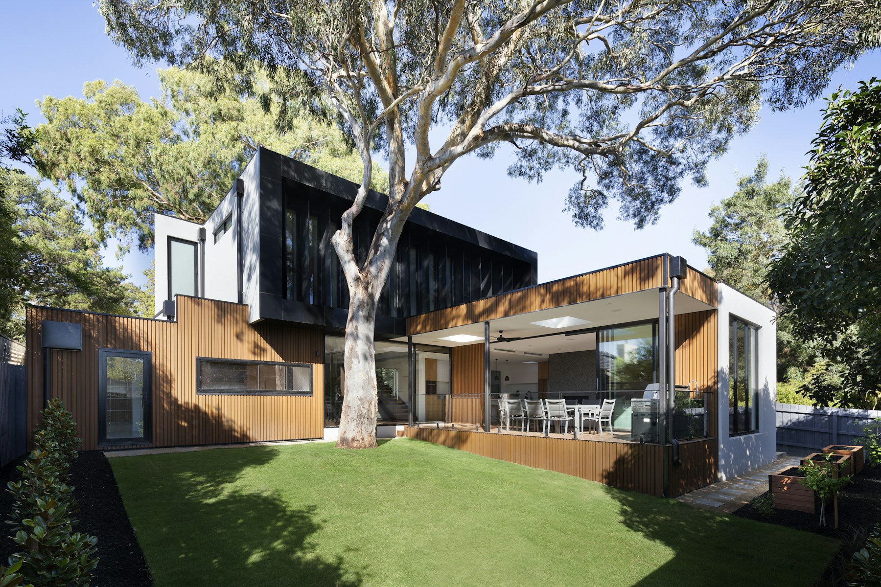 Modern residential architecture surrounded by mature North Carolina greenery